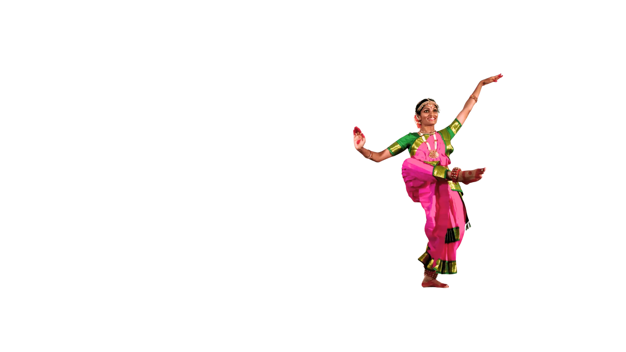 A Kuchipudi dancer mid-phrase, arms extended, on a lit stage